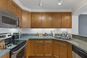 Villaggio on Yarrow Bay kitchen with dishwasher and wood cabinets