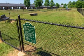 City Edge Flats Fenced-In Dog Park with Ample Green Space for Pets to Run and Play