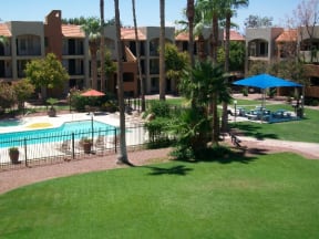 Exterior, landscaping, pool & pool patio at Casa Bella Apartments in Tucson, AZ