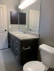 Large bathroom with dark vanity and large mirror