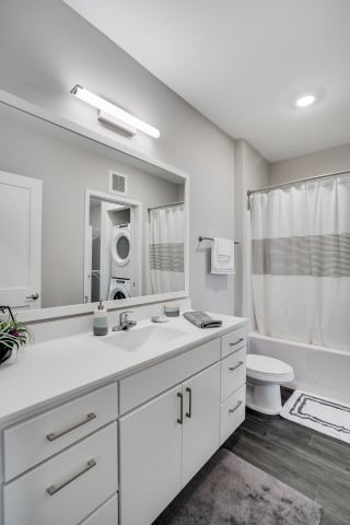 Spacious Bathroom with White Cabinetry
