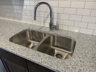 Haven-At-Uptown-Lincoln-NE-two-bedroom-apartment-Cloud-Mocha-finish Stainless steel undermount sink with a chrome faucet