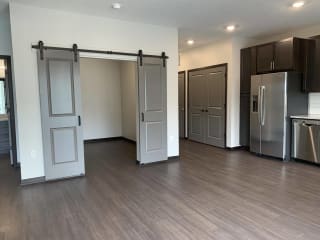 Den or office space with elegant double barn doors at Haven at Uptown