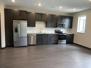 Open kitchen into living and dining area at Haven at Uptown