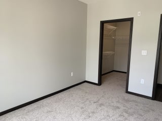 bedroom features spacious walk-in closet with shelving at Haven at Uptown