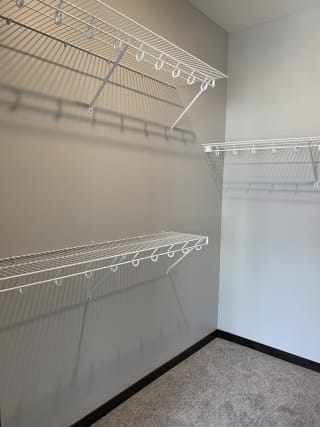 Walk-in closet with shelving and rods in the Peace floorplan at Haven at Uptown
