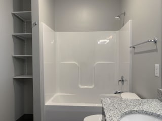 Haven-at-Uptown-Apartments-Lincoln-NE-one-bedroom-Peace-Mocha Shower and tub combo with linen storage close by