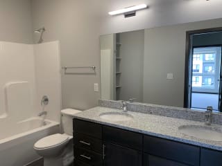 Spacious bathroom with double vanity and shower tub combo