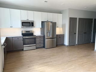 Spacious open kitchen with matching steel appliances and under cabinet lighting in serenity floorplan at Haven at Uptown