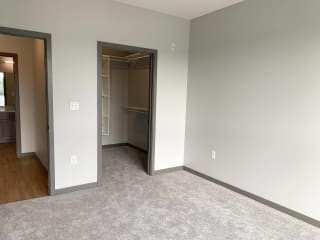 Bed room with large walk in closet with shelving