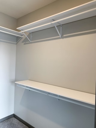 Walk-in closet with shelving and rods in the Serenity floorplan at Haven at Uptown