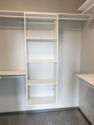 Haven-at-Uptown-Apartments-Lincoln-NE-one-bedroom-Serenity-premium-Slate-523 All white shelving and rods in walk in closet in serenity floor plan at Haven at Uptown