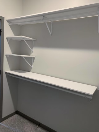 Haven-at-Uptown-Apartments-Lincoln-NE-one-bedroom-Serenity-premium-Slate-523 All white shelving and rods in walk in closet in serenity floor plan at Haven at Uptown