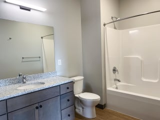 Haven-at-Uptown-Apartments-Lincoln-NE-one-bedroom-Serenity-premium-Slate-523 Bathroom with light gray finish and granite counter tops