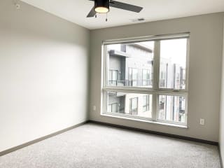 Haven-at-Uptown-Apartments-Lincoln-NE-one-bedroom-Serenity-premium-Slate-523 Carpeted bedroom with large floor to ceiling window