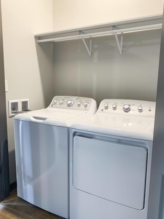 In unit laundry washer and dryer in closet with shelf for storage