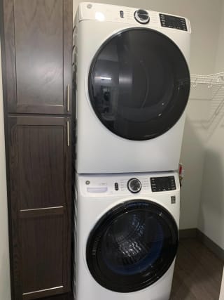 Haven-at-Uptown-Apartments-Lincoln-NE-Studio-Zen-Mocha Stacked full size front load washer and dryer with linen storage in apartment in Lincoln