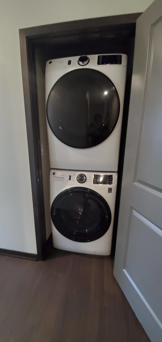 Stacked front-loader washer and dryer set in a closet