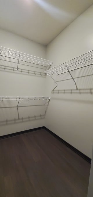 Haven-at-Uptown-Lincoln-NE-2-bedroom-apartment-Aura-Mocha-finish-11 Walk in closet with wire shelving for clothes and shoe storage