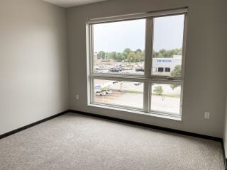 Empty bedroom in a two bedroom apartment with a view outside to north Lincoln, Nebraska