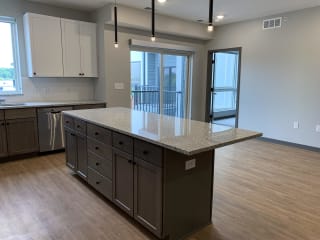 Floating kitchen island with ample counter space at haven at uptown in lincoln nebraska