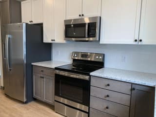 Kitchen with matching stainless steel appliances and white cabinets at haven at uptown in lincoln nebraska
