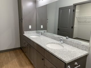 Full bath with double vanity and large mirror at haven at uptown in lincoln nebraska