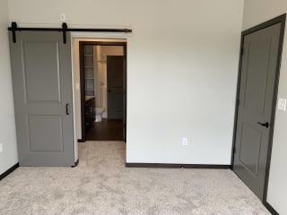 Bedroom looking into pass through closet and connected bathroom