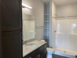 Bathroom with dark brown cabinets in the mocha finish at Haven at Uptown
