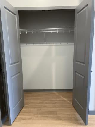 Empty hall closet with bifold doors