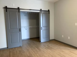 Large walk in closet with sliding barn doors on the outside