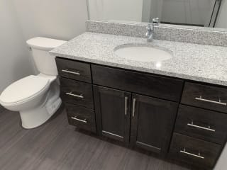 Nest Studio Floor Plan in Mocha Finish at Haven at Uptown Bathroom with cabinet for storage and light granite counters