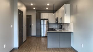 kitchen with white and gray cabinets and matching stainless steel appliances