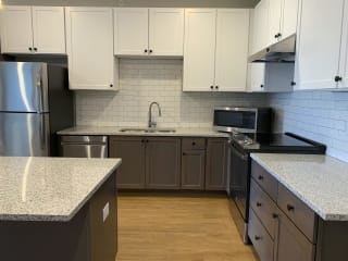 Luxury kitchen with matching stainless steel appliances and large granite counters at Haven at Uptown in Lincoln, Nebraska