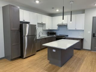 Luxury kitchen with matching stainless steel appliances and large granite counters at Haven at Uptown in Lincoln, Nebraska