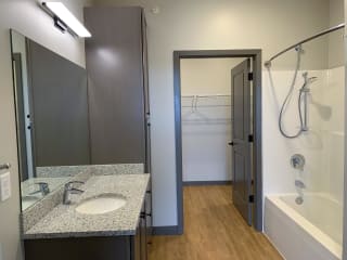 Spacious bathroom with shower tub combo walk in closet attached at Haven at Uptown in Lincoln, Nebraska