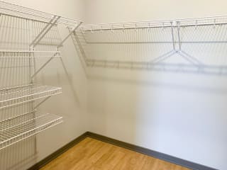 large walk in closet with rods and shelving for storage and hanging space
