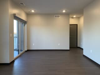 living area with hardwood floors and balcony access