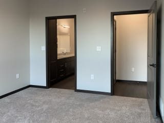 master bedroom with access to walk in closet and private bathroom