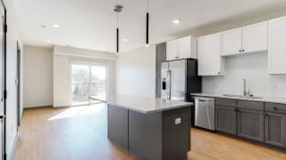 Bliss (1 bed, 1 bath) in Slate finish Open concept kitchen and living space in the Bliss floor plan at Haven at Uptown in Lincoln, NE
