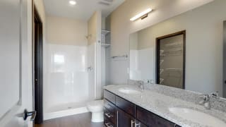 Large master bathroom with dual sink counters at Haven at Uptown in Lincoln, NE
