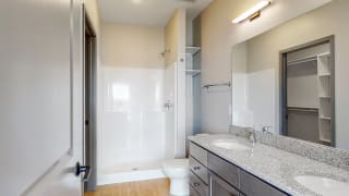 Shine (2 bed, 2 bath) in Slate finish View of dual sink counter tops and shower in bathroom attached to the master bedroom at Haven at Uptown in Lincoln, NE