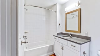 Spacious bathroom with tub and shower and large vanity in a 2 bedroom penthouse floor plan Midtown Crossing Apartments Omaha