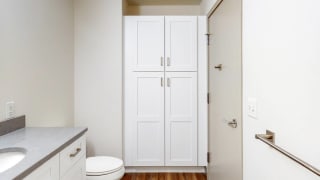 Ample storage in the bathroom linen closet in a 2 bedroom penthouse floor plan at Midtown Crossing Apartments Omaha