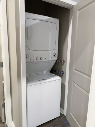Stacked washer and dryer included in the plum studio apartment