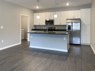 Kitchen with white cabinets and dark granite counters The Flats at Shadow Creek in Lincoln Nebraska