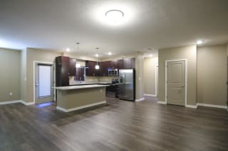 Large living and dining area with hardwood floors