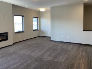 carpeted living room and nook area