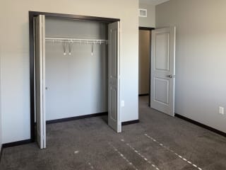 carpeted bedroom with large closet and shelving space
