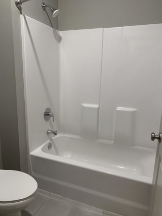 bathroom with white shower and tub combo